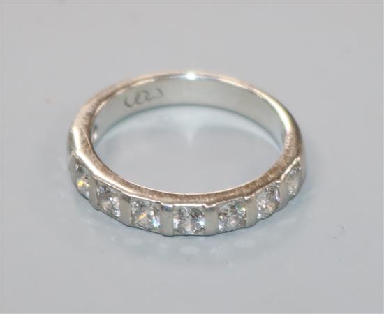 A palladium and nine stone diamond half eternity ring, size M.